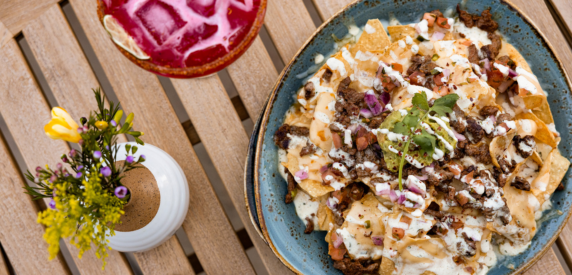 Plate of Nachos with beans ,guacamole, and sour cream